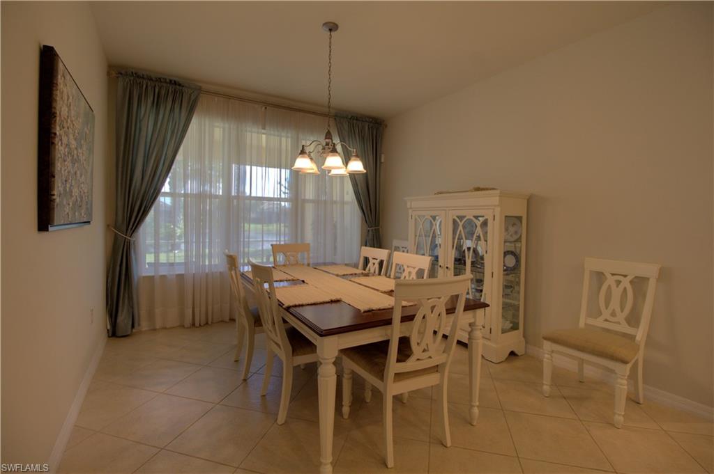 8615 Palermo Court Naples, FL 34114 - Photo 13 of 50 a view of a dining room with furniture and chandelier