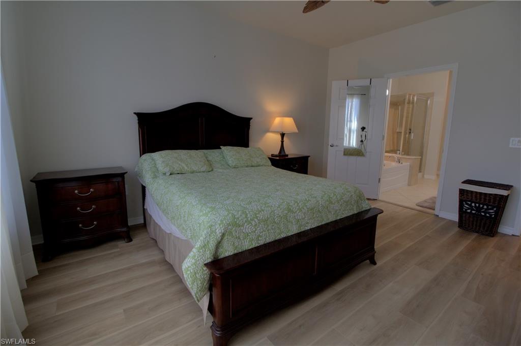 8615 Palermo Court Naples, FL 34114 - Photo 16 of 50 a bedroom with a bed and a tv on table