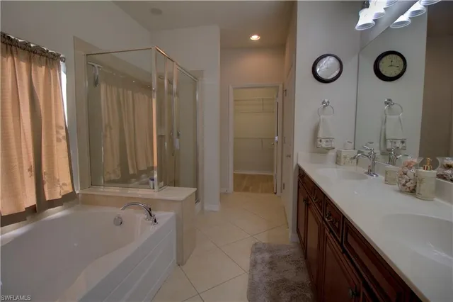 a bathroom with a tub sink and mirror