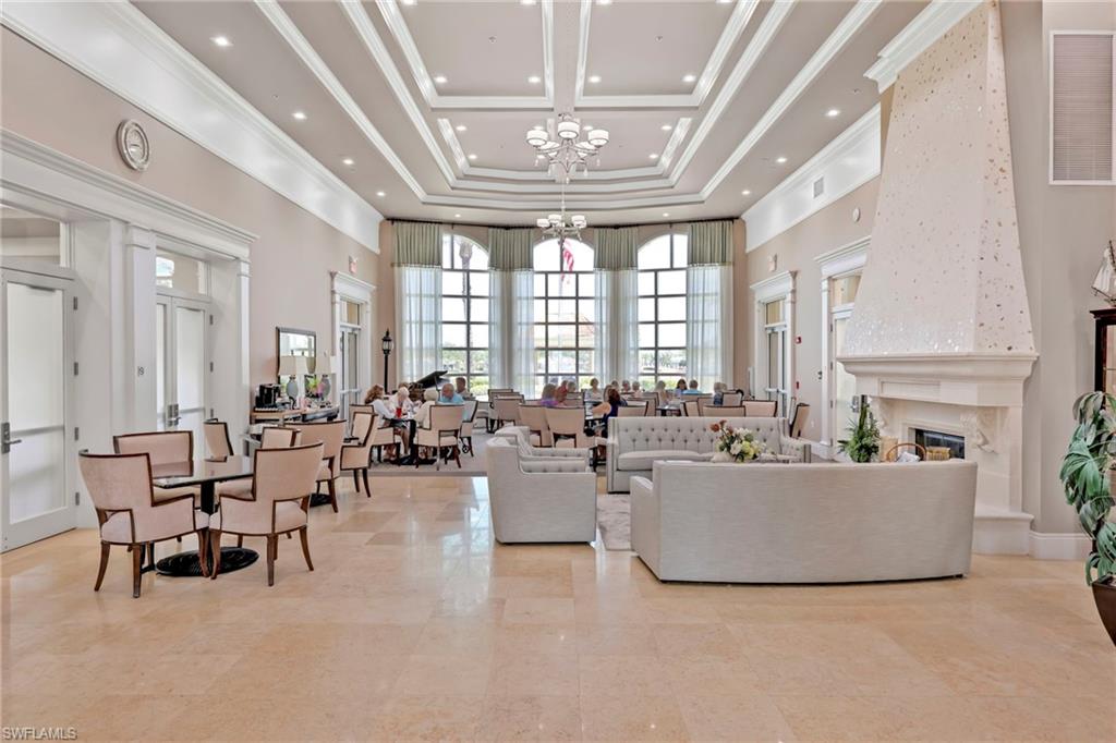 8615 Palermo Court Naples, FL 34114 - Photo 27 of 50 a living room with furniture and a chandelier