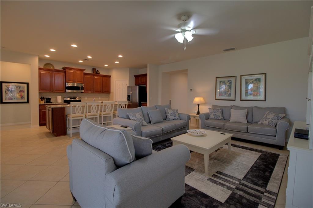 8615 Palermo Court Naples, FL 34114 - Photo 5 of 50 a living room with furniture and a chandelier