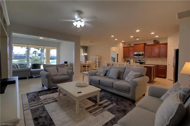 a living room with furniture and a chandelier