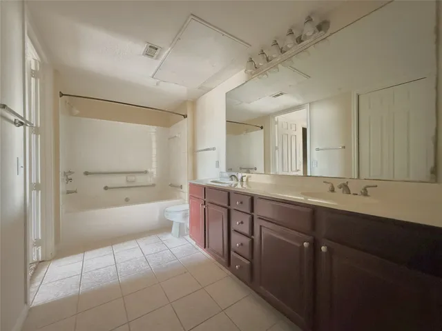 a bathroom with a sink a toilet and bathtub