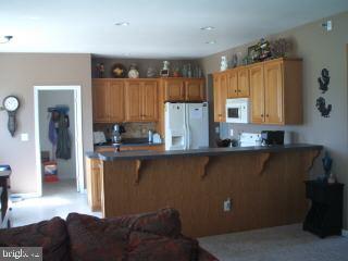 7965 Richardson Road Willards, MD 21874 - Photo 7 of 13 a kitchen with a refrigerator and a stove top oven