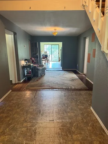a room with wooden floor and sliding window