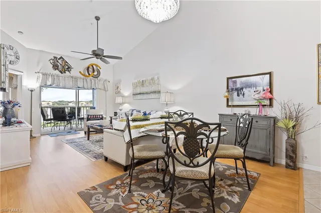 a view of a dining room with furniture a chandelier and wooden floor