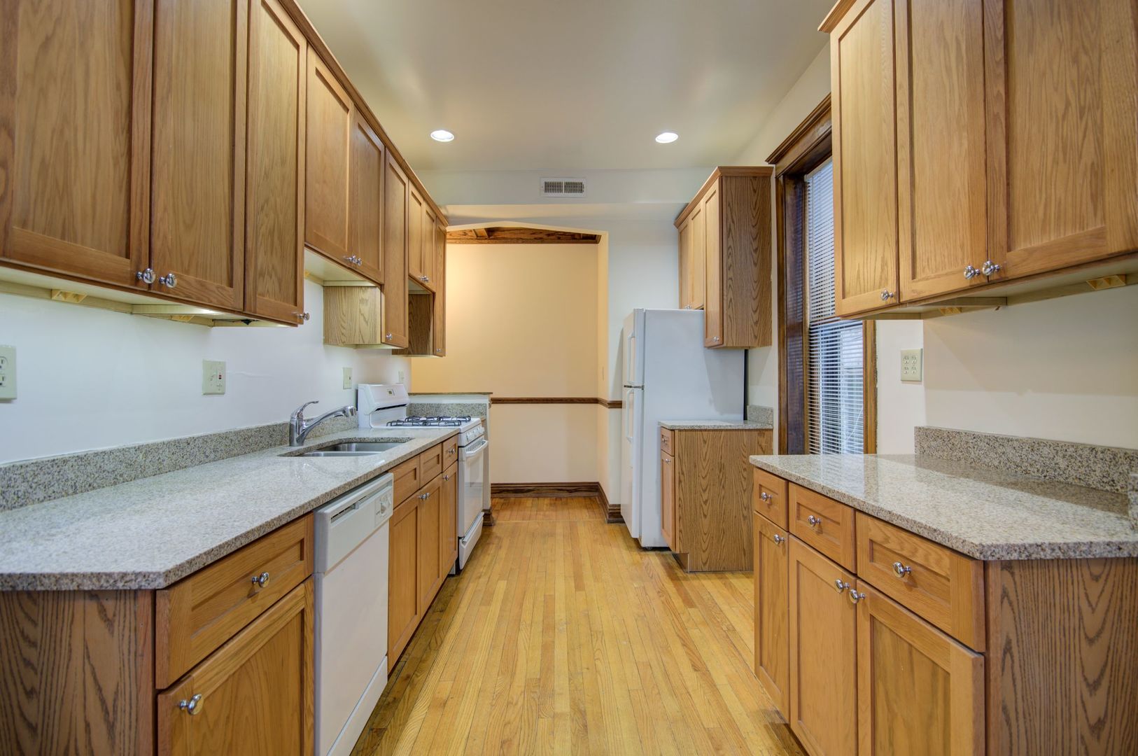 845 West Sheridan Road, Unit 1 Chicago, IL 60613 - Photo 14 of 17 a kitchen with a sink a refrigerator and cabinets