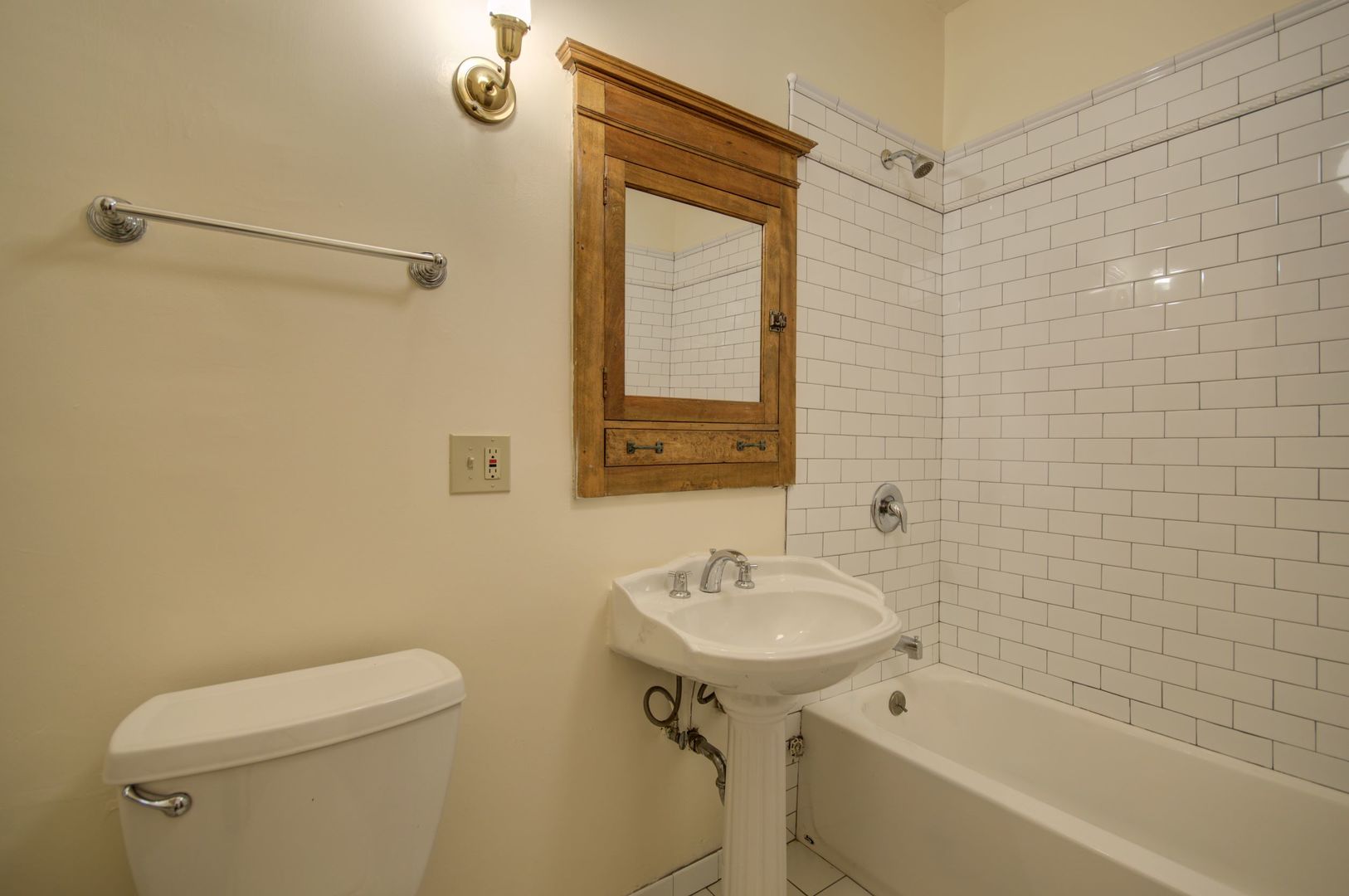 845 West Sheridan Road, Unit 1 Chicago, IL 60613 - Photo 16 of 17 a bathroom with a sink a toilet and shower