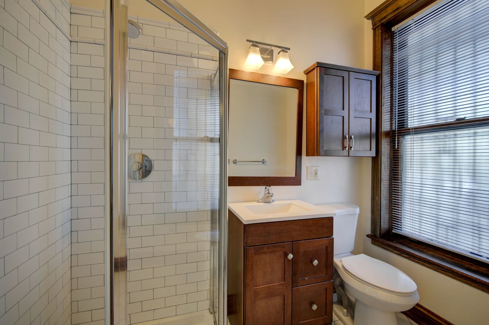 845 West Sheridan Road, Unit 1 Chicago, IL 60613 - Photo 17 of 17 a bathroom with a sink toilet vanity and shower