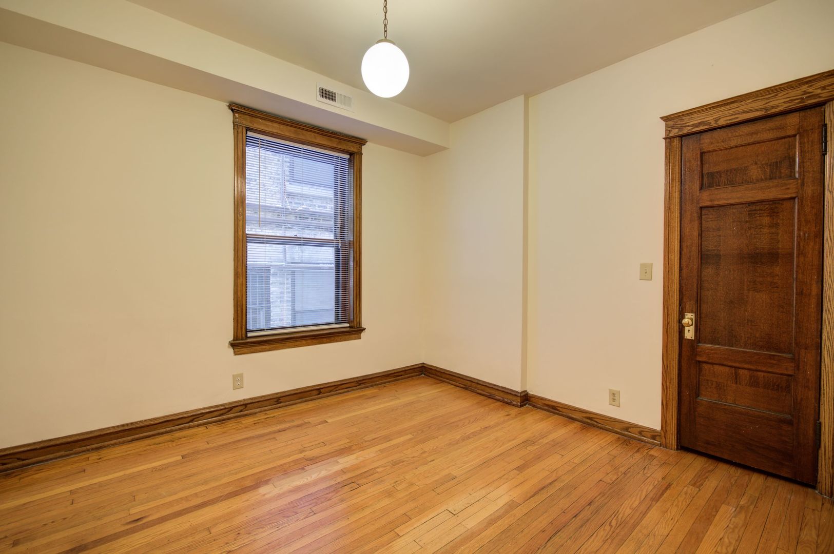 845 West Sheridan Road, Unit 1 Chicago, IL 60613 - Photo 7 of 17 an empty room with wooden floor and windows