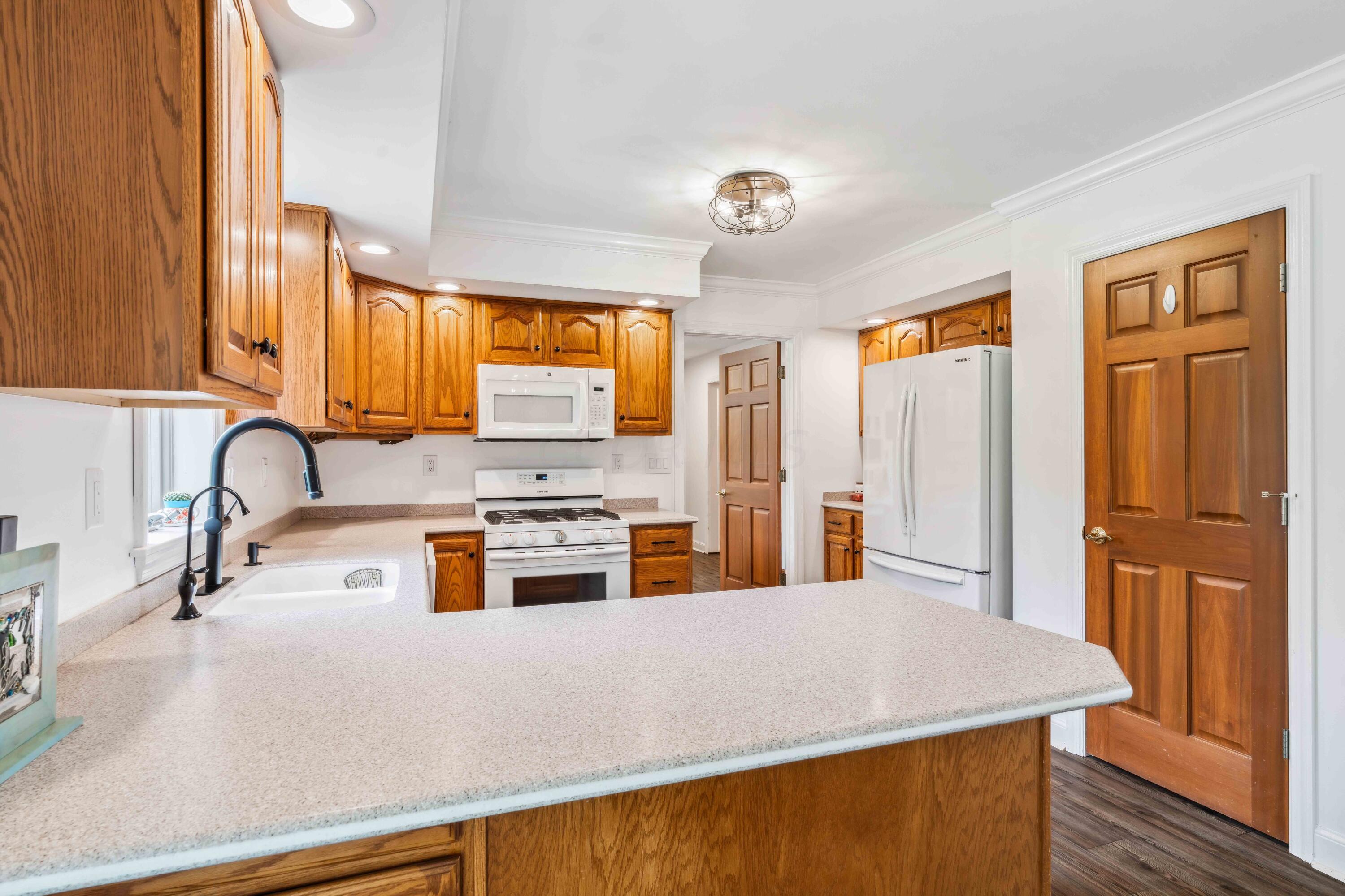 8884 Weiser Road Waldo, OH 43356 - Photo 14 of 37 Kitchen with Corian Countertops, new faucet, New Bosch dishwasher in 2020, NEW Samsung Gas Range 2020. Pantry plus Countertop Seating!