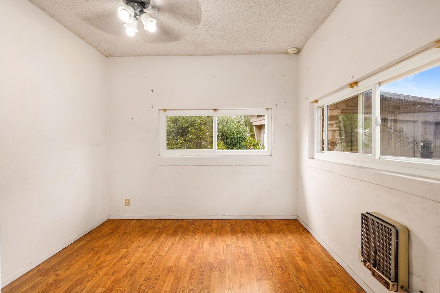 982 Oso Road Ojai, CA 93023 - Photo 12 of 21 an empty room with a fireplace and windows
