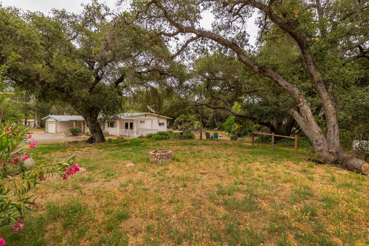 982 Oso Road Ojai, CA 93023 - Photo 2 of 21 a front view of a house with a yard and trees