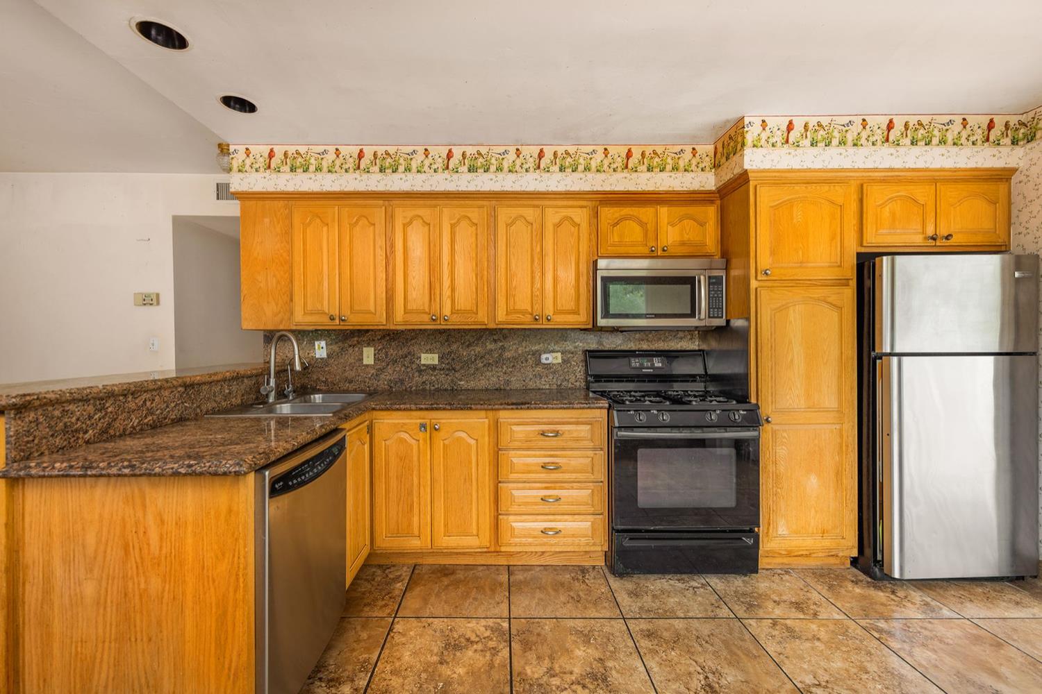 982 Oso Road Ojai, CA 93023 - Photo 8 of 21 a kitchen with stainless steel appliances granite countertop a refrigerator and a stove