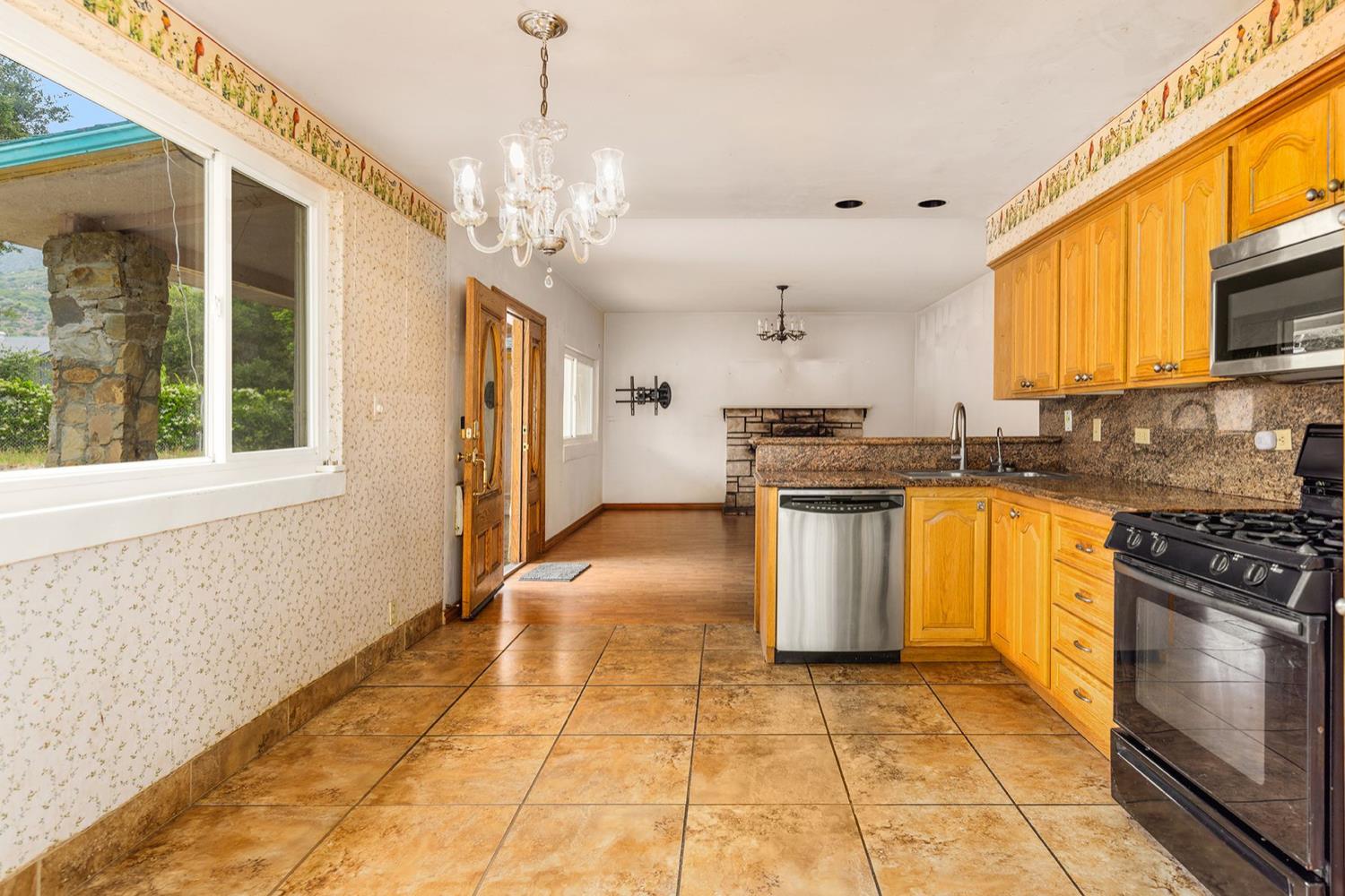 982 Oso Road Ojai, CA 93023 - Photo 9 of 21 a kitchen with stainless steel appliances granite countertop a stove a sink dishwasher and a refrigerator with wooden floor