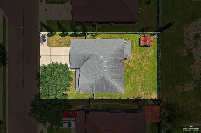 an aerial view of a house with a yard basket ball court and outdoor seating