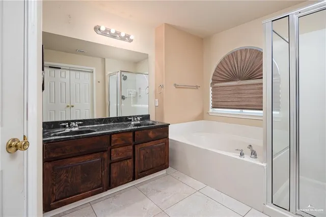 a bathroom with a tub a sink and a mirror