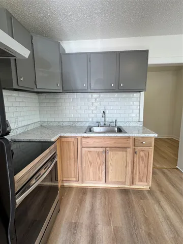 a kitchen with granite countertop white cabinets and white appliances