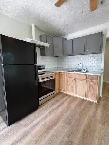 a kitchen with a sink stainless steel appliances and cabinets