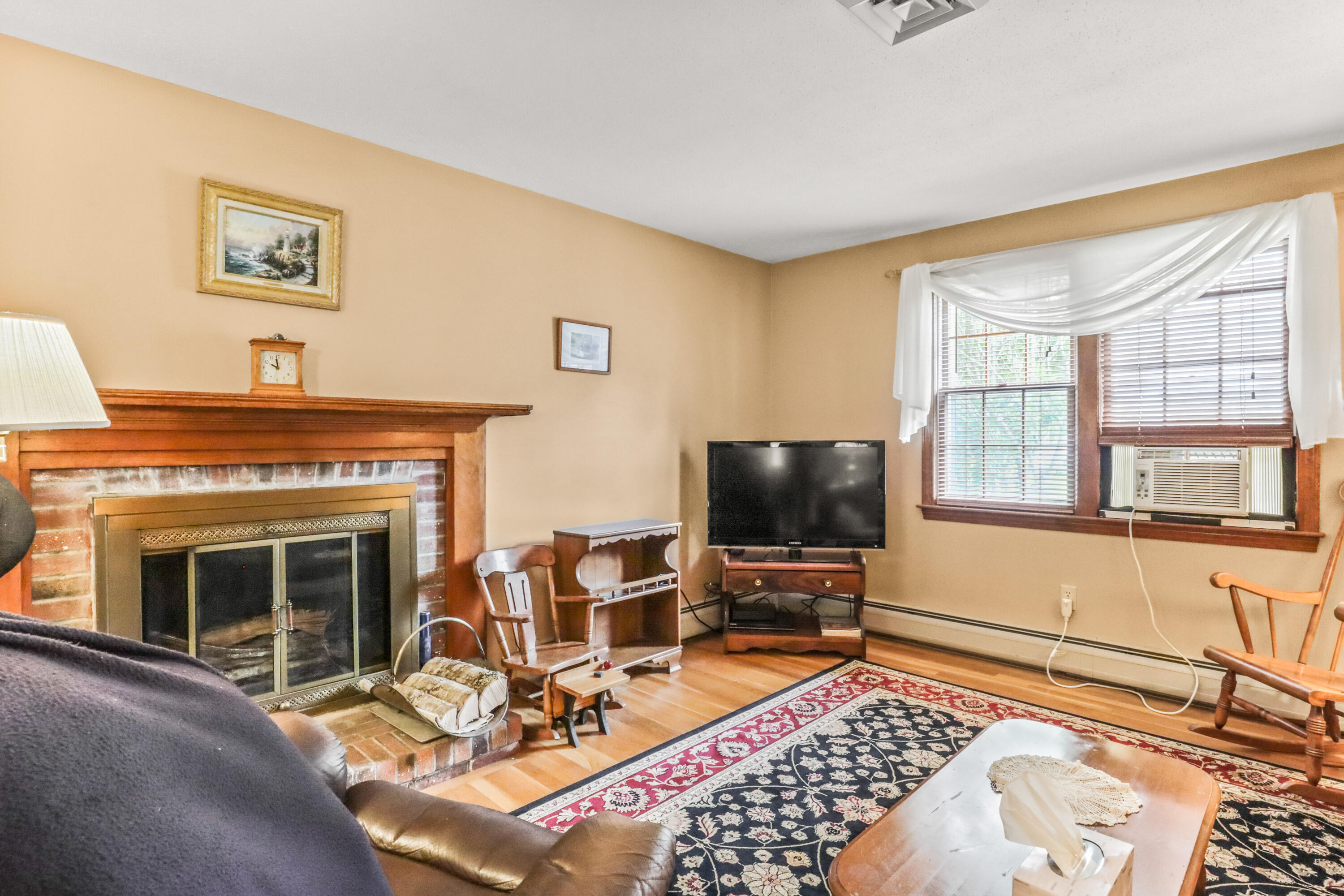 75 James Otis Road Centerville, MA 02632 - Photo 11 of 30 a living room with furniture a flat screen tv and a fireplace
