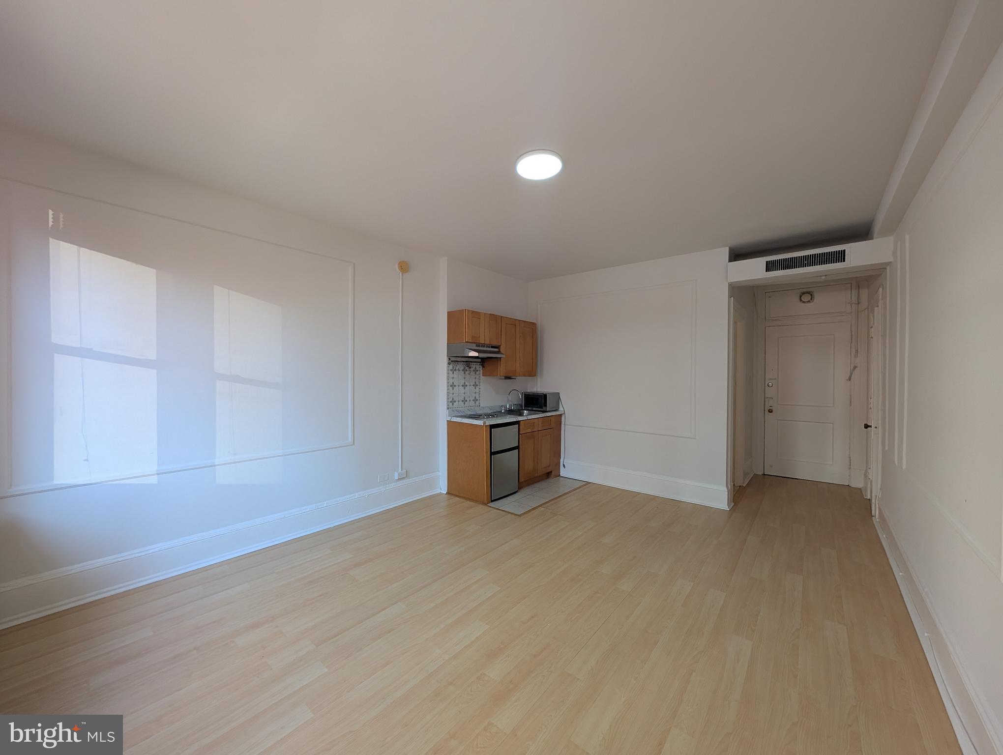 1324 Locust Street, Unit 618 Philadelphia, PA 19107 - Photo 11 of 34 a view of a kitchen with refrigerator and wooden floor