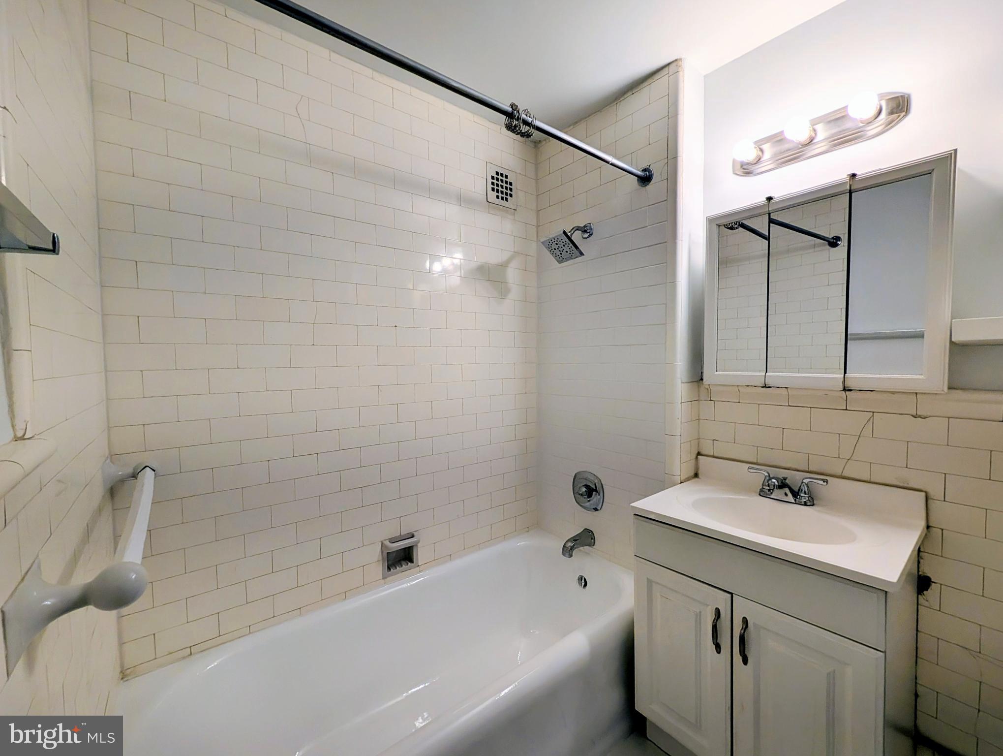 1324 Locust Street, Unit 618 Philadelphia, PA 19107 - Photo 16 of 34 a bathroom with a sink mirror toilet and bathtub