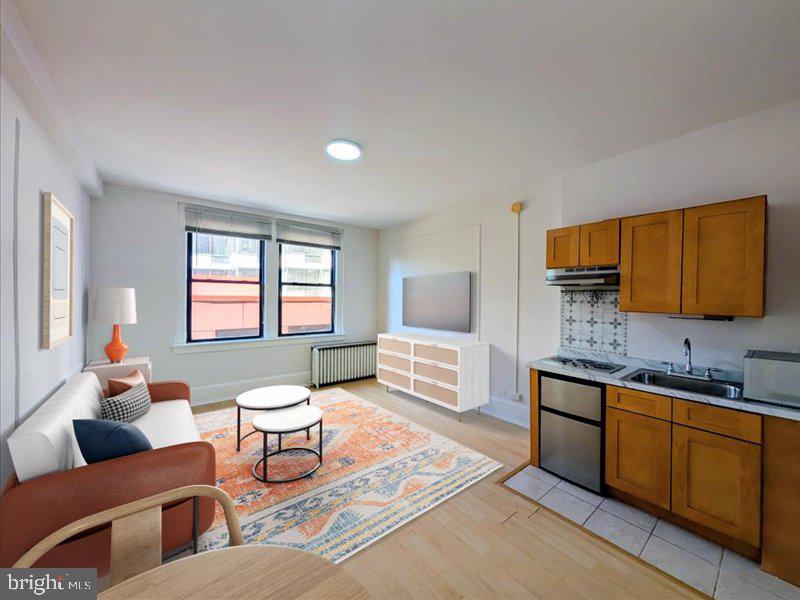 1324 Locust Street, Unit 618 Philadelphia, PA 19107 - Photo 3 of 34 a living room with furniture and a flat screen tv