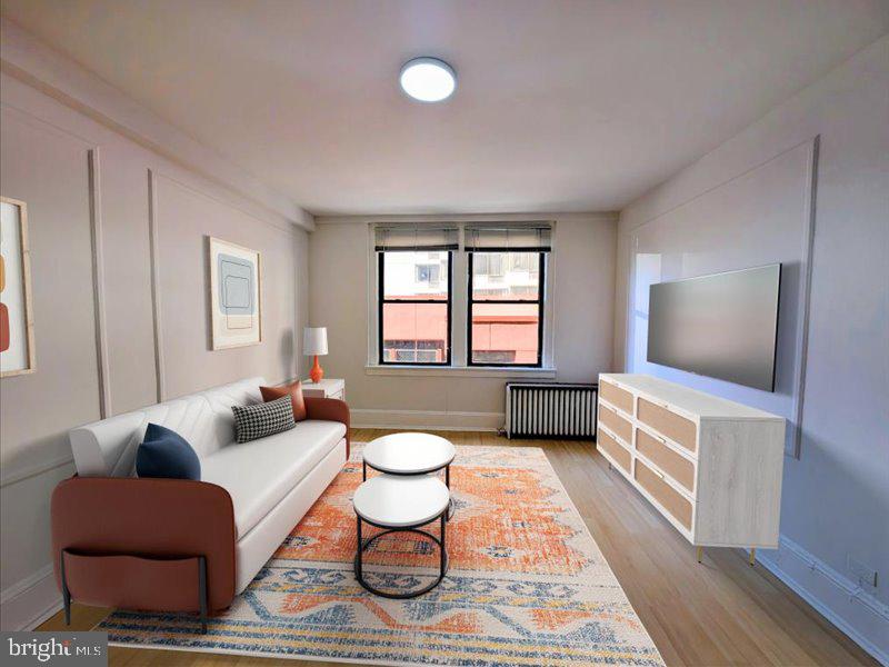 1324 Locust Street, Unit 618 Philadelphia, PA 19107 - Photo 7 of 34 a living room with furniture and a rug