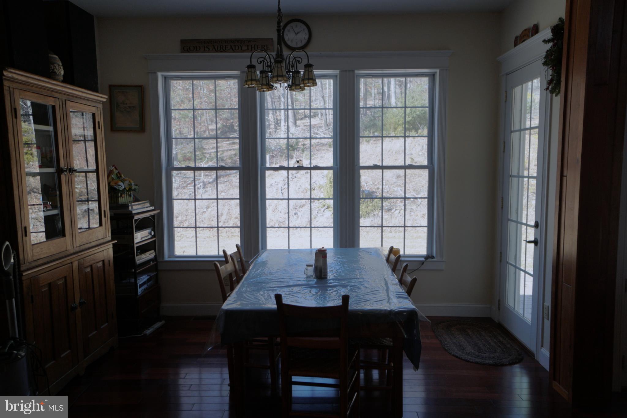 255 Troublesome Valley Road Franklin, WV 26807 - Photo 24 of 72 a view of a dining room with furniture window and wooden floor