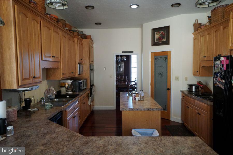 255 Troublesome Valley Road Franklin, WV 26807 - Photo 25 of 72 a kitchen with sink a refrigerator and cabinets