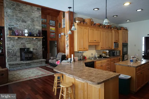 a kitchen with sink refrigerator and stove