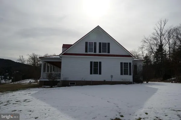 a front view of a house with yard and parking space
