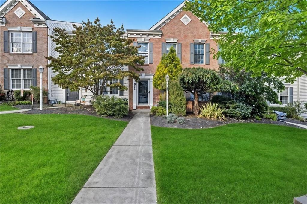 a front view of a house with a garden