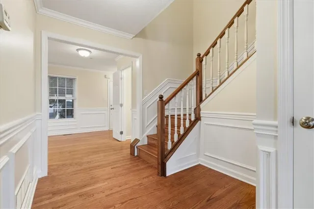 a view of an entryway with wooden floor and stairs