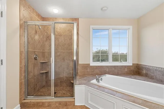 a bathroom with a bathtub and a shower