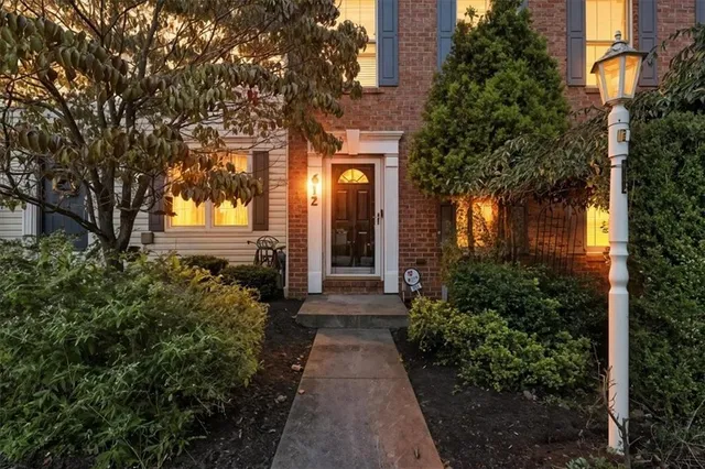 a view of a house with brick walls and a pathway