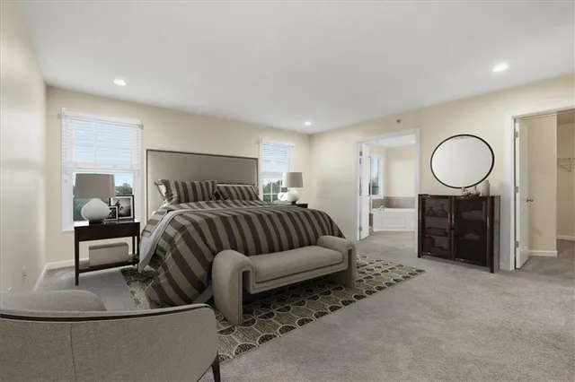 a bedroom with a large bed a couch and dresser