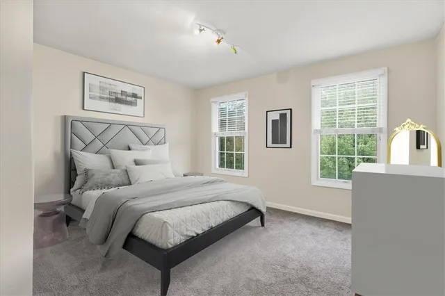 a large bed sitting in a bedroom next to a window