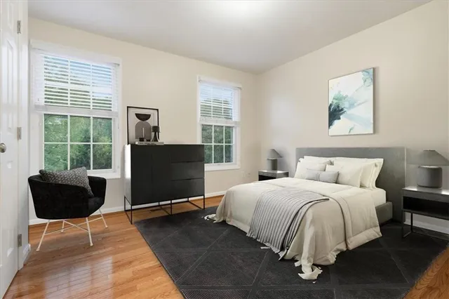 a bedroom with a bed and wooden floor