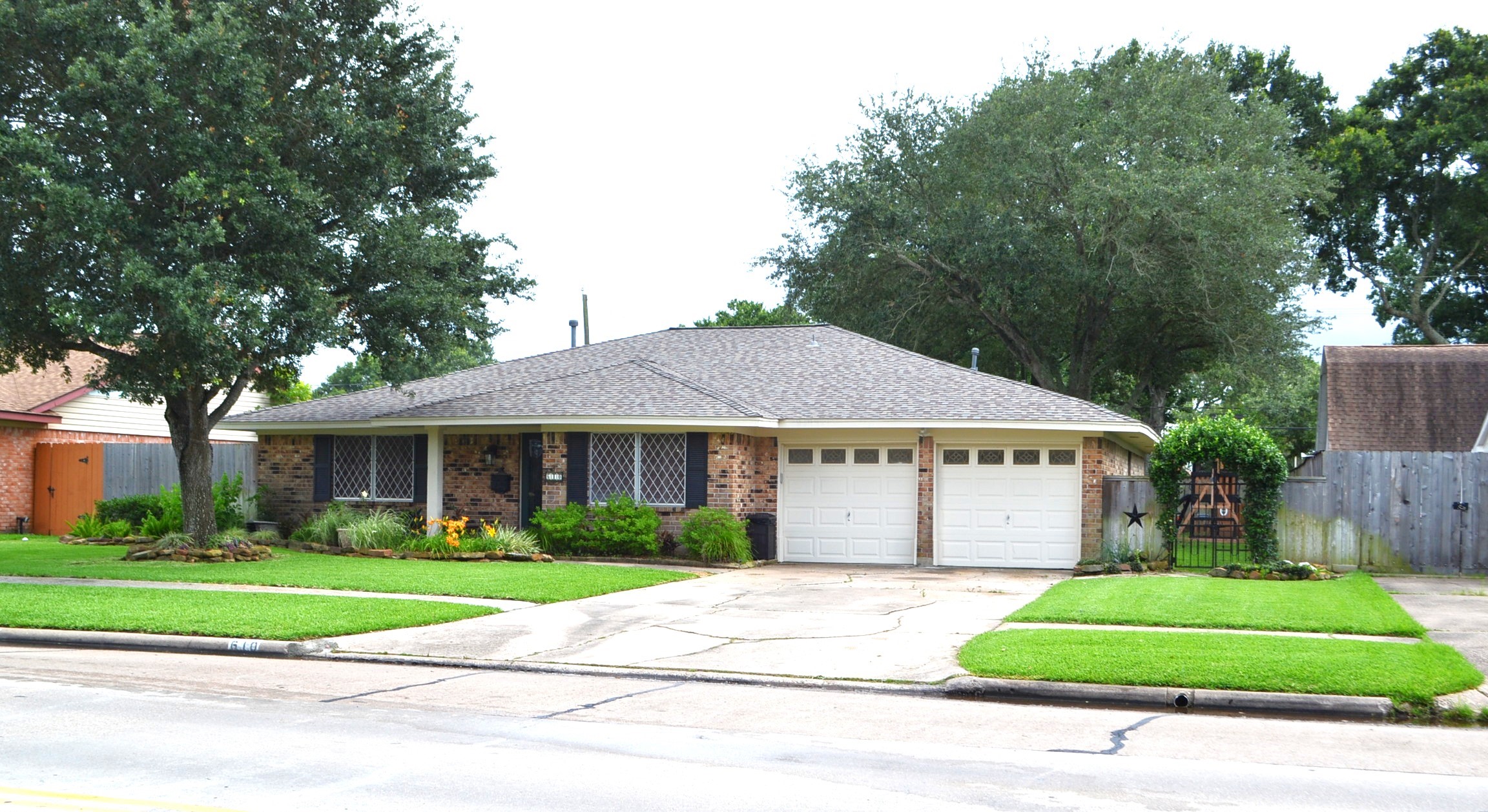 610 East X Street Deer Park, TX 77536 - Photo 3 of 44 a view of street along with a garden and plants