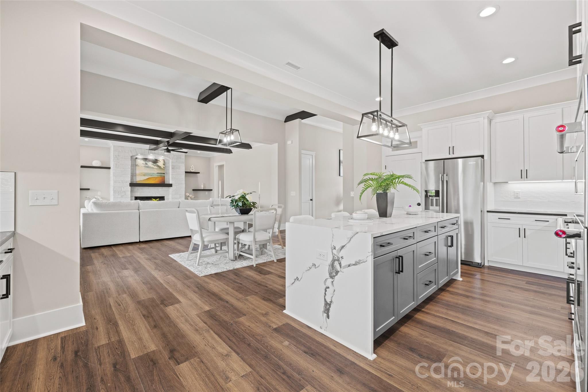 254 Triple Ponds Court Clover, SC 29710 - Photo 11 of 45 a kitchen with stainless steel appliances a kitchen island hardwood floor sink stove and wooden floor