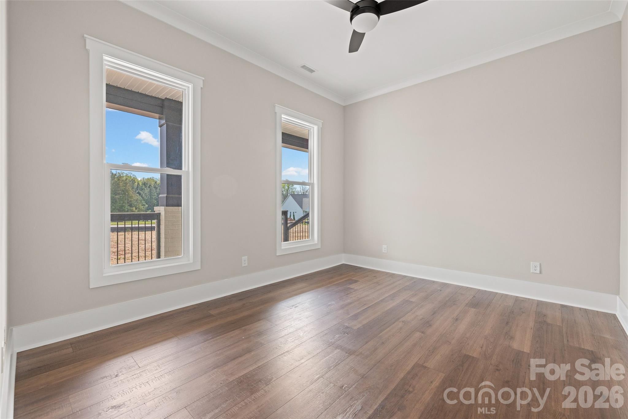254 Triple Ponds Court Clover, SC 29710 - Photo 33 of 45 an empty room with wooden floor fan and windows