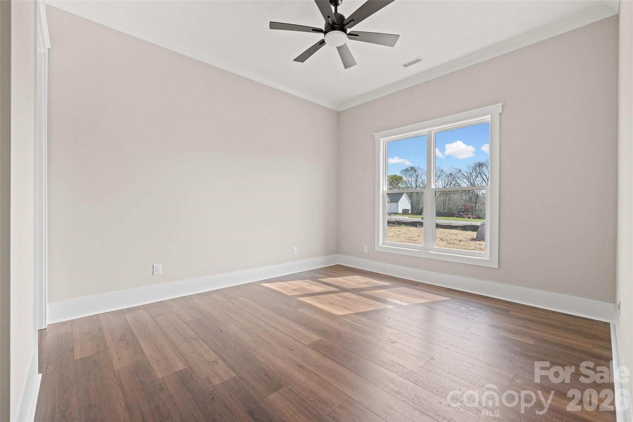 254 Triple Ponds Court Clover, SC 29710 - Photo 35 of 45 an empty room with wooden floor fan and windows