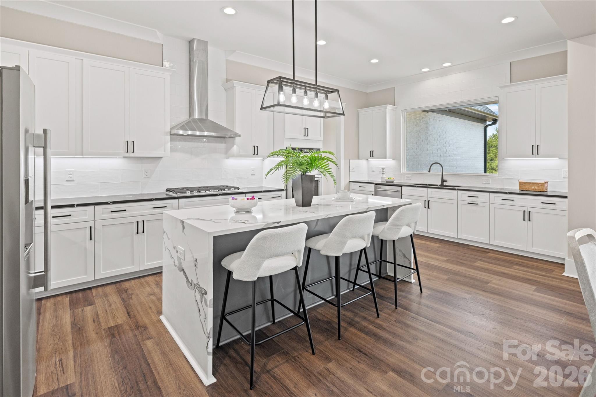 254 Triple Ponds Court Clover, SC 29710 - Photo 10 of 45 a kitchen with center island wooden floor and stainless steel appliances