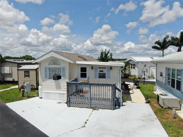 a view of a house with wooden floor and a yard