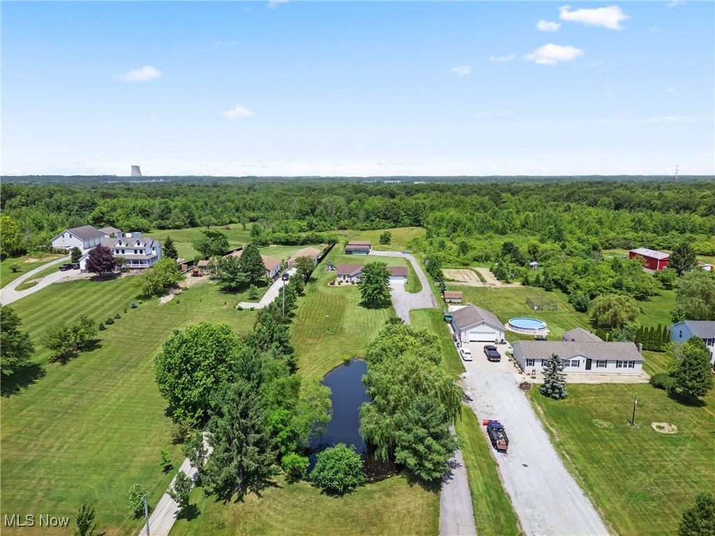 5215 River Road Madison, OH 44057 - Photo 28 of 36 Drone / aerial view of a heavily wooded area and a nearby body of water