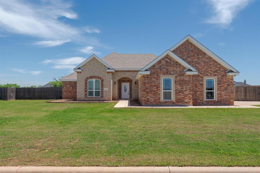 201 Rafter Drive, Unit T Tuscola, TX 79562 - Photo 1 of 1 View of front of house featuring brick siding, a front lawn, roof with shingles, and fence