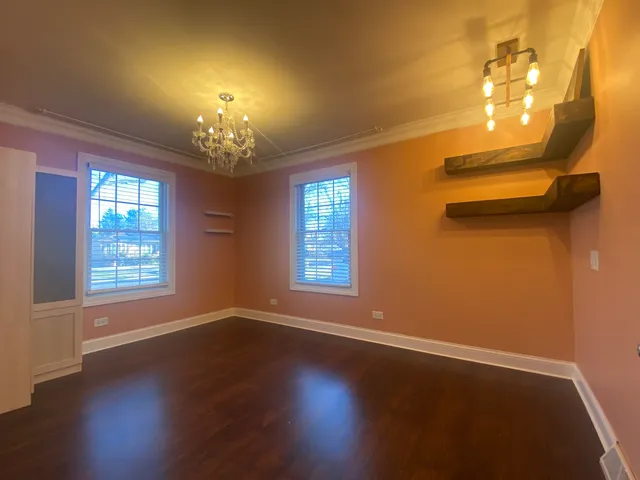 a view of a livingroom with a window and wooden floor
