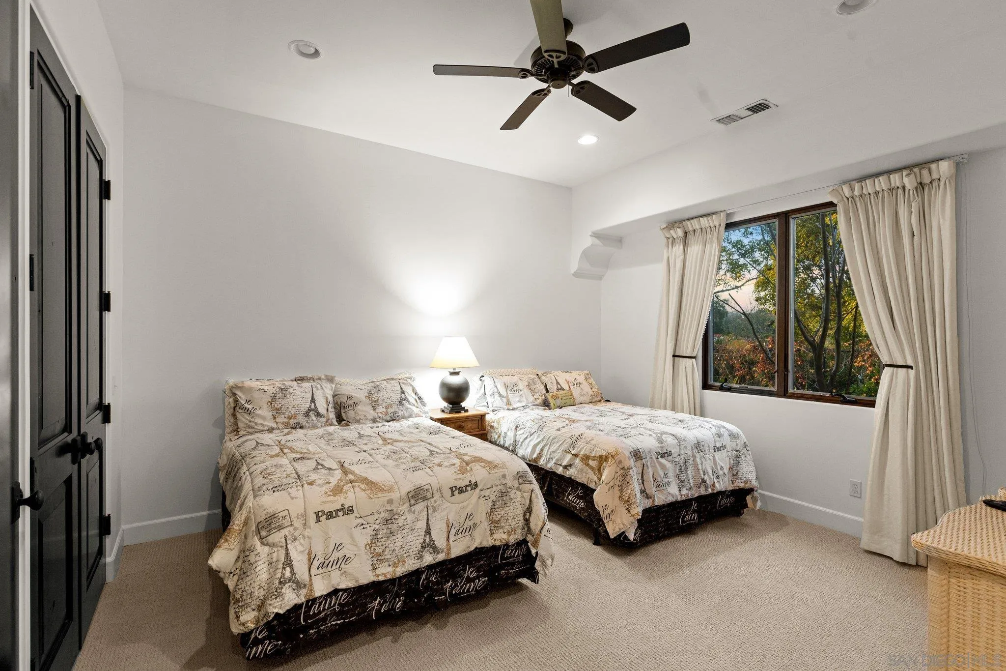 29746 Nella Lane Bonsall, CA 92084 - Photo 18 of 39 a bedroom with two beds chandelier and a window