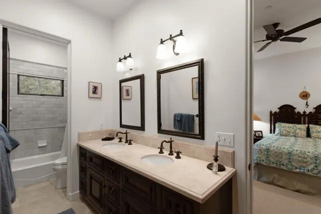 a en suite bathroom with a sink and a mirror